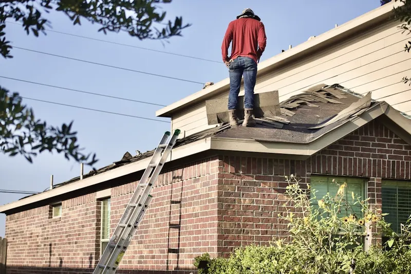 Professional roofer working on a residential roof in Hy-view